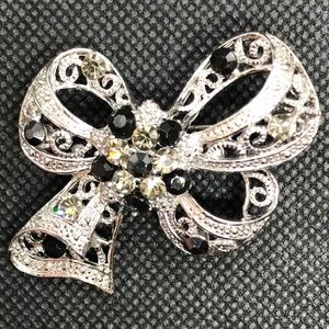 Silver bow pin with crystal accents